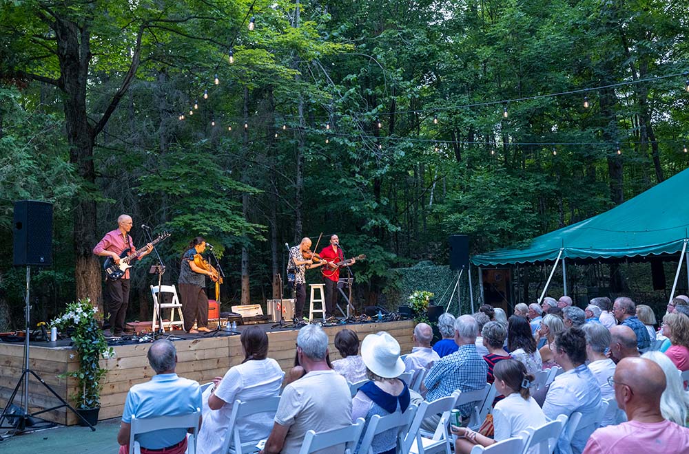 A group of 4 musicians on an outdoor stage