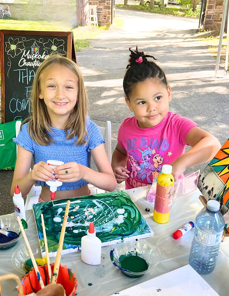 Two girls participate in arts and crafts